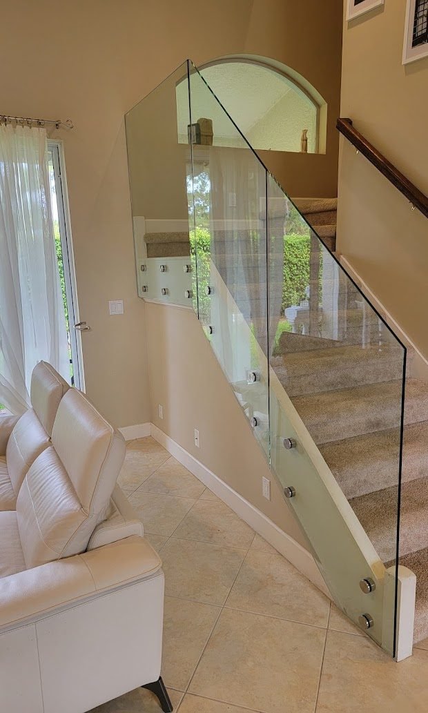Frameless glass stair railing with stainless standoffs